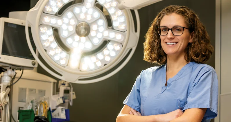 Dr. Lindsey Perea poses in operating room