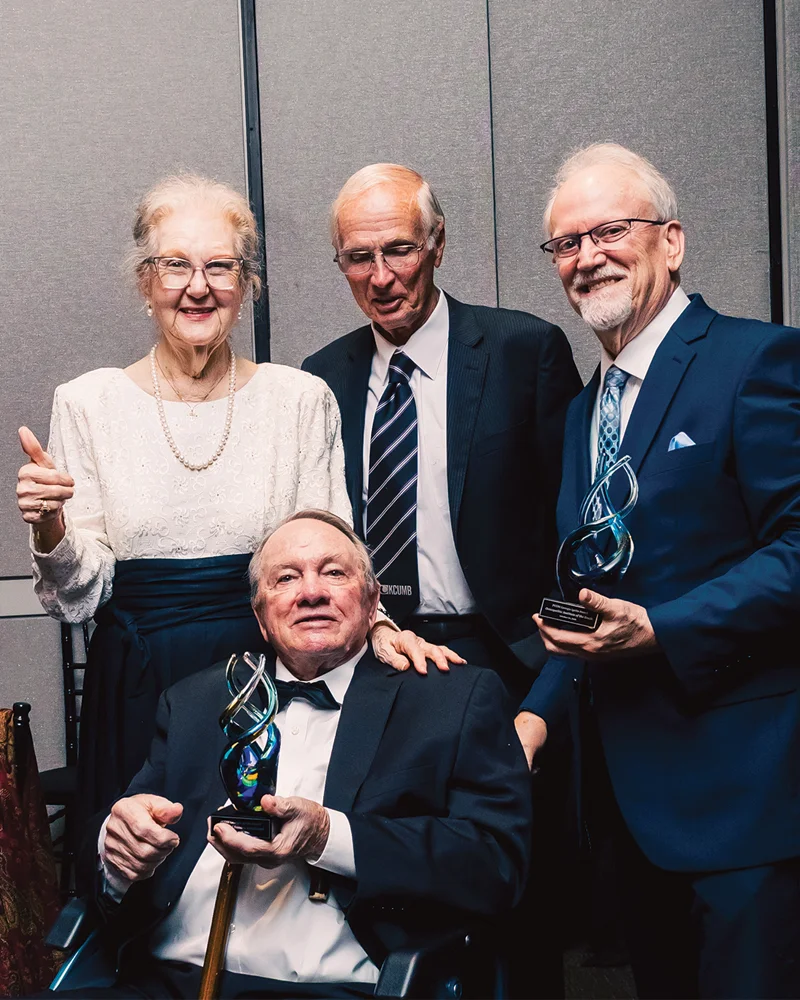 Sandra and Clyde Strickland and representatives of the Osteopathic Institute of the South pose with an award