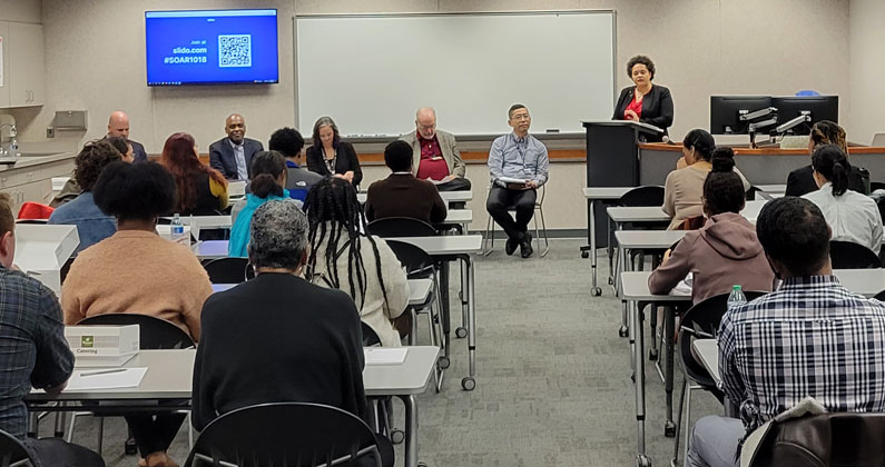 SOAR career panel guests sit in front of a classroom full of PCOM employees