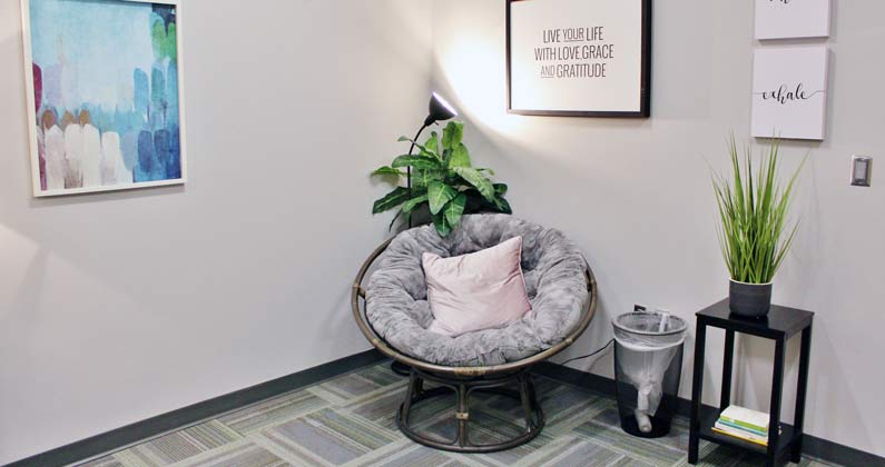 Chair, pillows and other furniture in the meditation room at PCOM Georgia