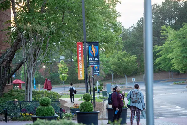 PCOM Georgia students walking outside the main building.