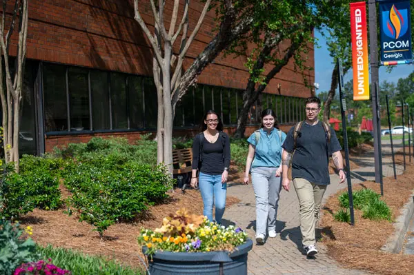 PCOM Georgia students walking outside the main building.