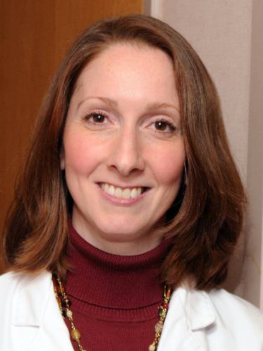 Headshot of Lauren Noto Bell, DO, FNAOME, wearing a physician white coat