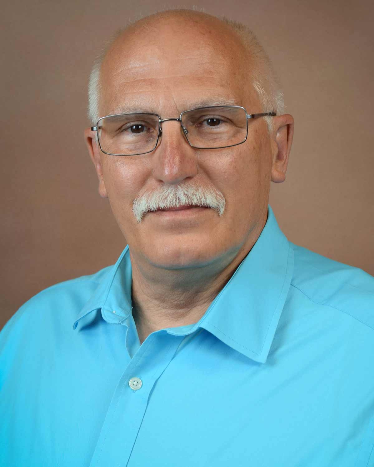 Professional headshot photograph of George Fredrick, MD