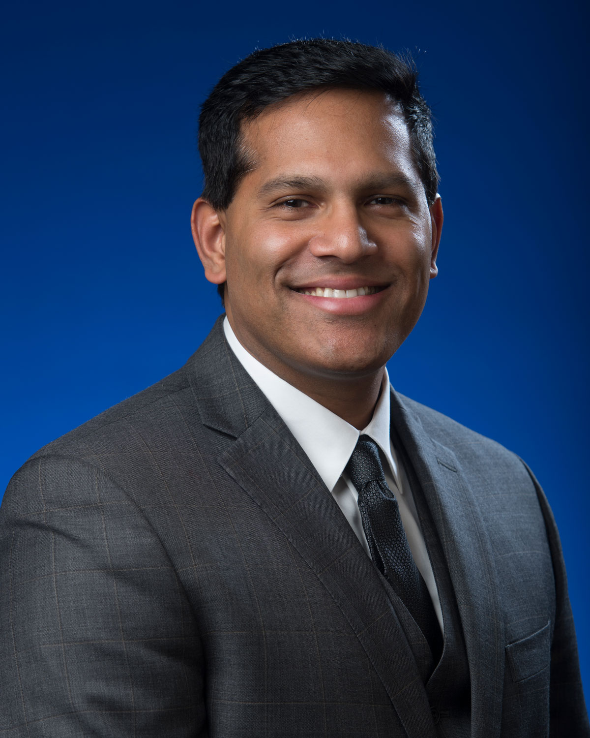 Professional headshot photograph of Dr. Samuel John