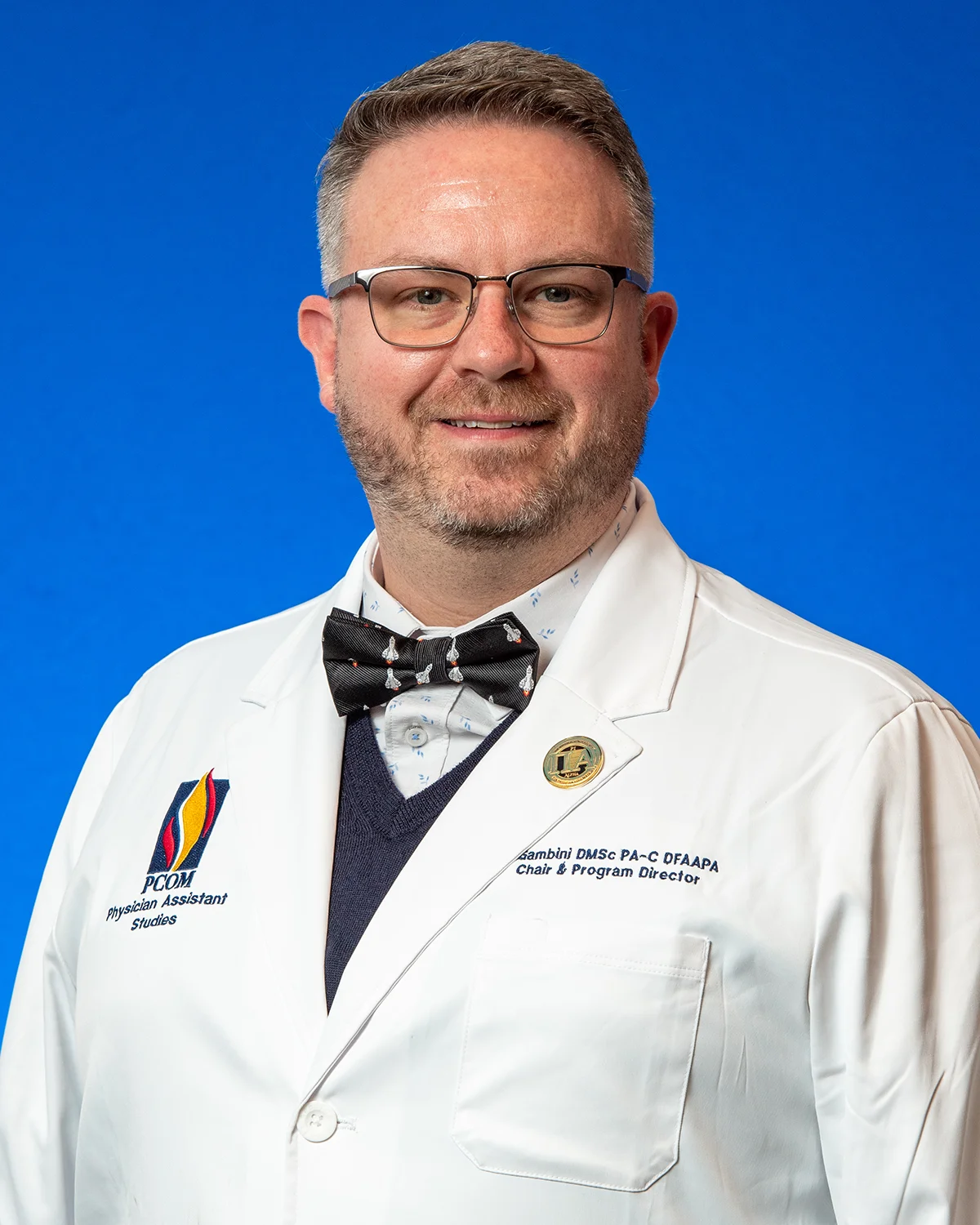 Professional headshot photo of PCOM's PA Chair and Program Director Justin M. Gambini, DMSc, PA-C, DFAAPA