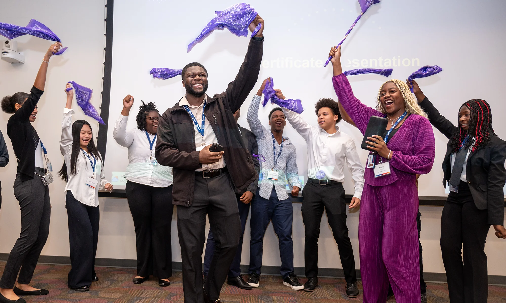 High schoolers and medical students smiling and cheering during an youth outreach program at PCOM Georgia