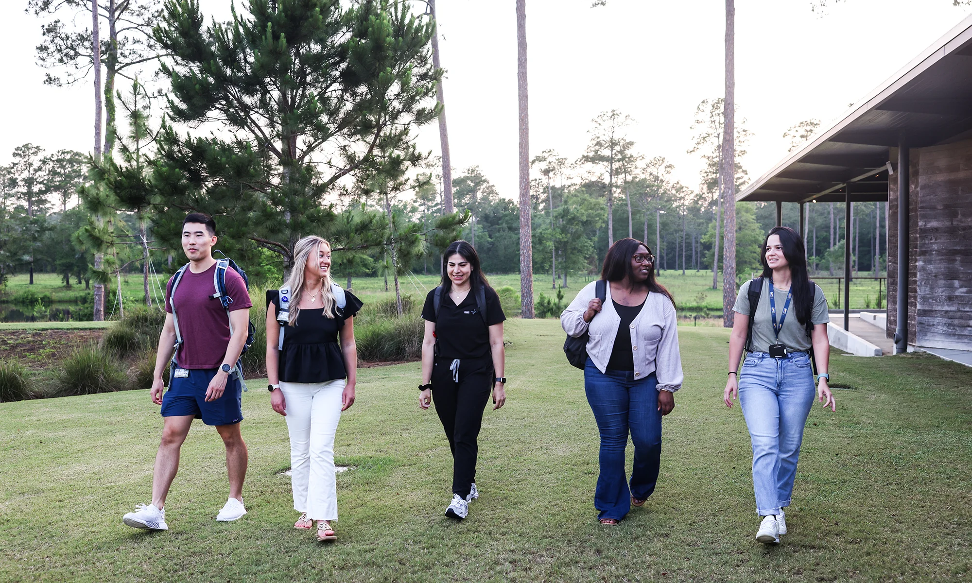 Graduate students smile as they walk outside the grounds at PCOM South Georgia