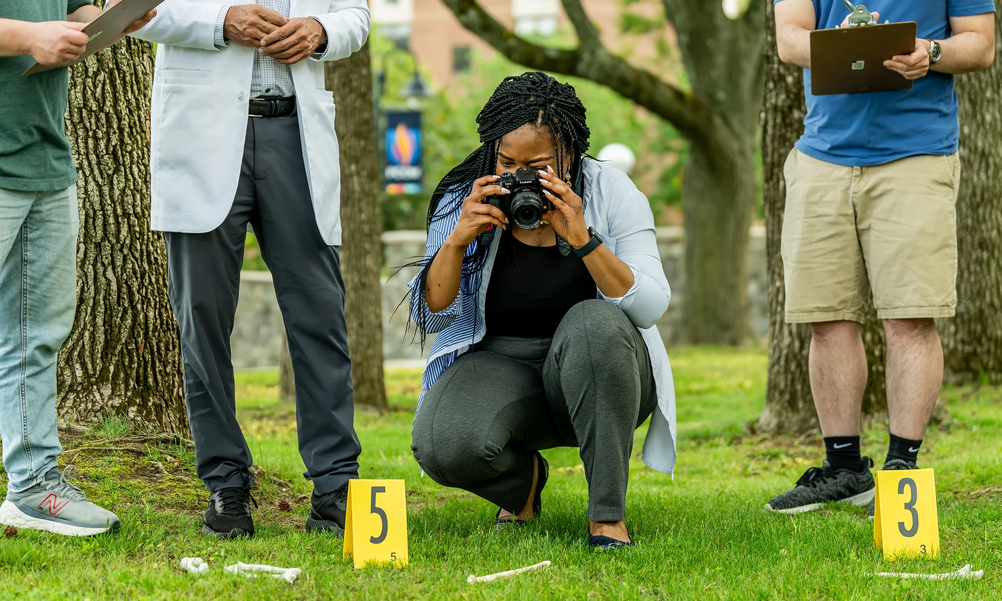 Forensic medicine student taking photographs of a mock crime scene at PCOM