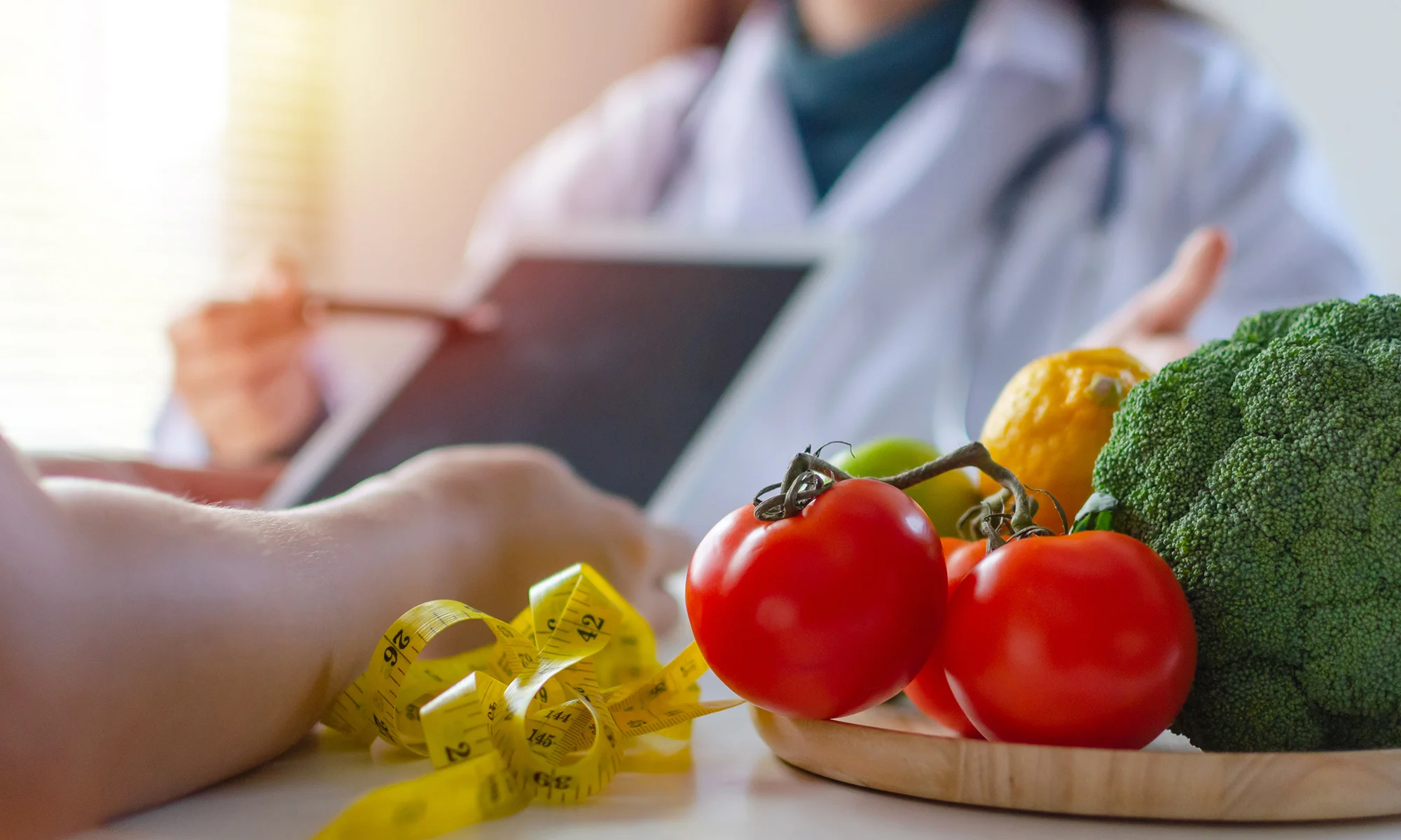 PCOM medical students discuss nutrition research over a plate of healthy foods and vegetables