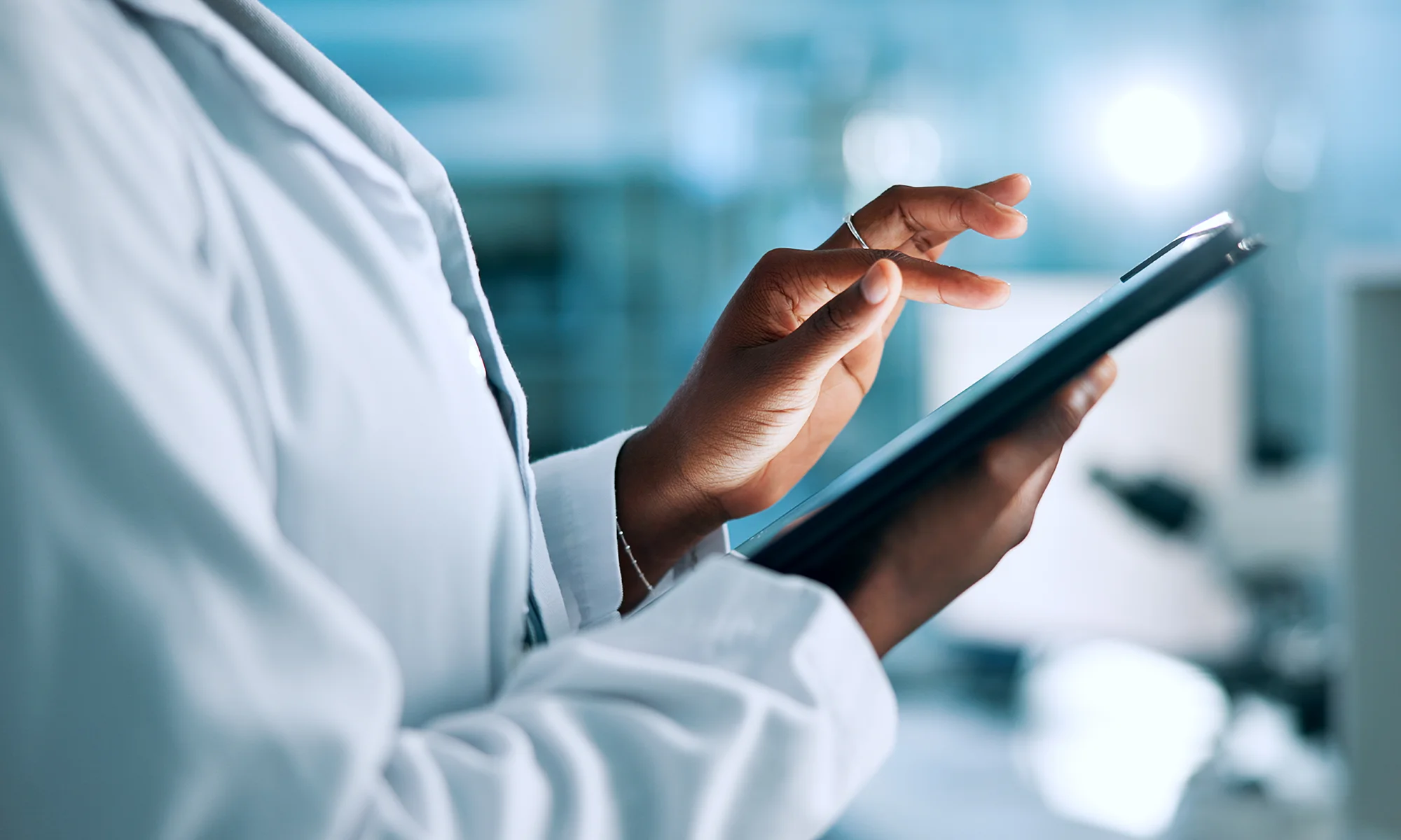 Macro photo of a physician using tablet technology