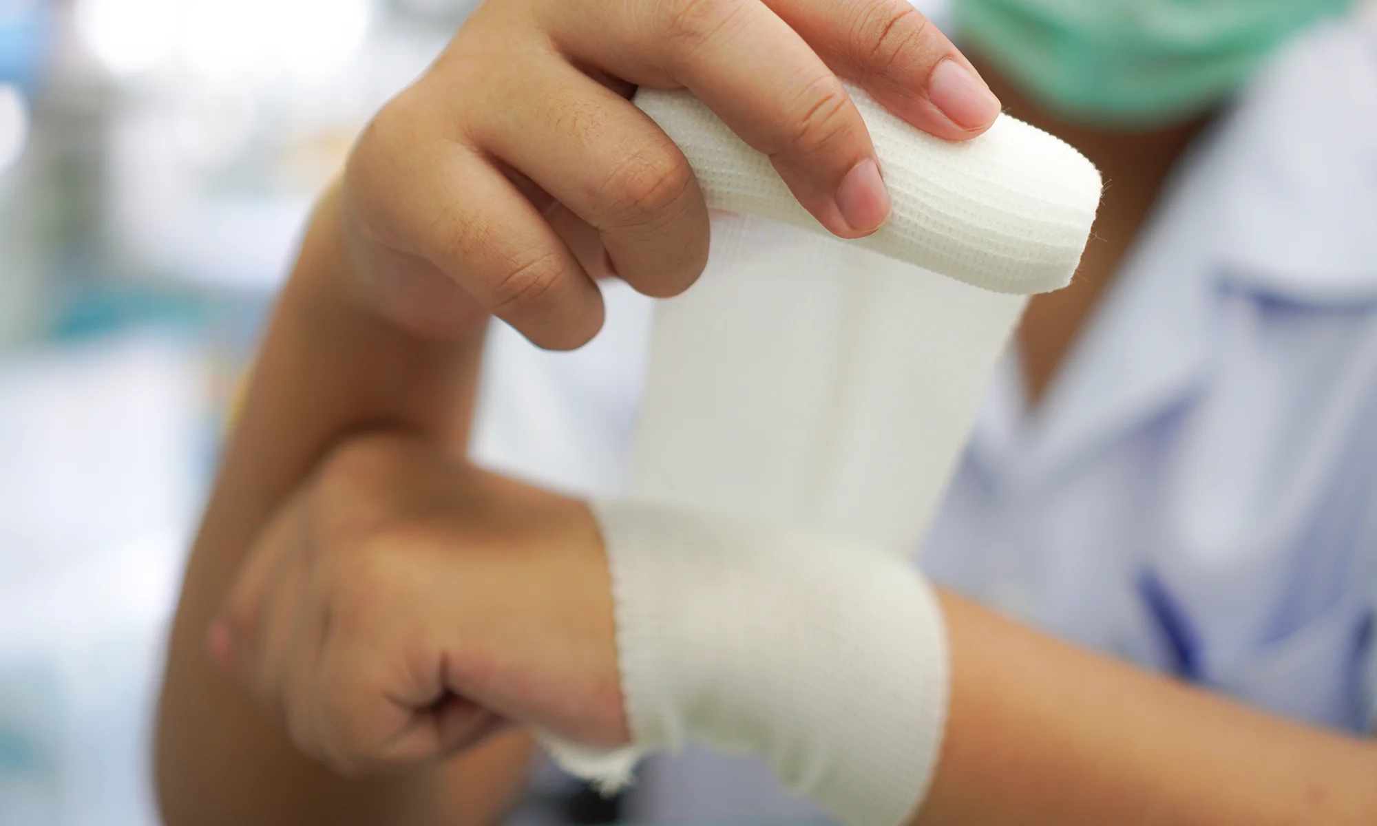 Physician wrapping a wound in gauze representing wound healing and tissue research