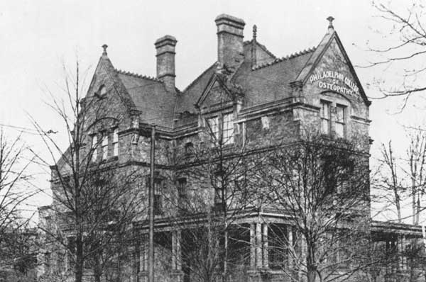 Black and white photo of a seven-story Victorian stone mansion in Philadelphia