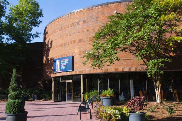 View of the front doors and landscaping of the PCOM Georgia campus building in Suwanee