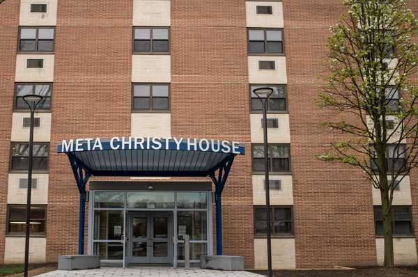 The front doors and façade of the Meta Christy House apartment building