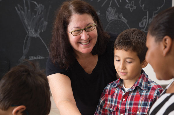 PCOM school psychology students interacting with grade school children in a classroom