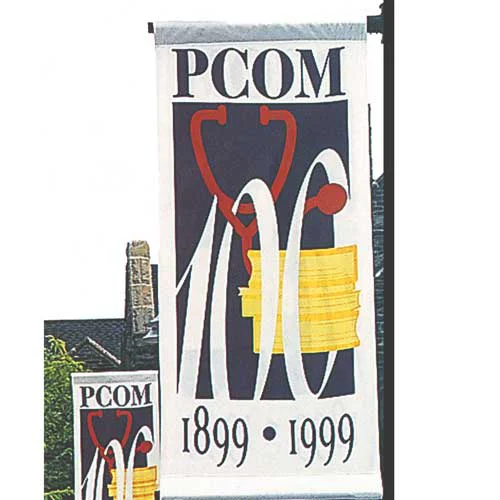 PCOM campus flags displaying 100, 1899, 1999 and art representing the College's centennial anniversary