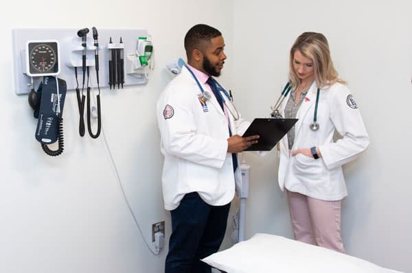 A photo of two PCOM medical students. PCOM is committed to diversity and that commitment is a key part of PCOM's strategic plan.