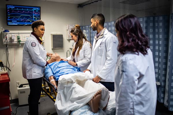 A photo of PCOM medical students working in the simulation center at PCOM's Philadelphia campus.