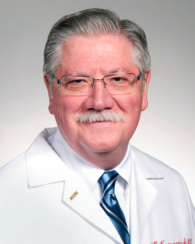 Professional headshot photograph of Joseph Kaczmarczyk, DO, MPH, MBA in his physician white coat