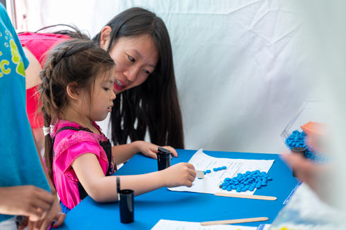 A young child participates in a counting activity