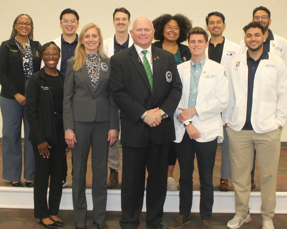 PCOM Georgia students stand with leaders from the American Osteopathic Association (AOA) during a lunch and learn session