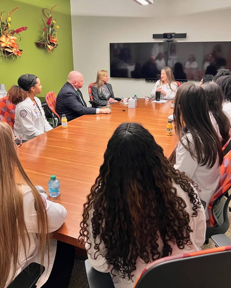 PCOM Georgia students sit around a conference table with leaders from the American Osteopathic Association (AOA)