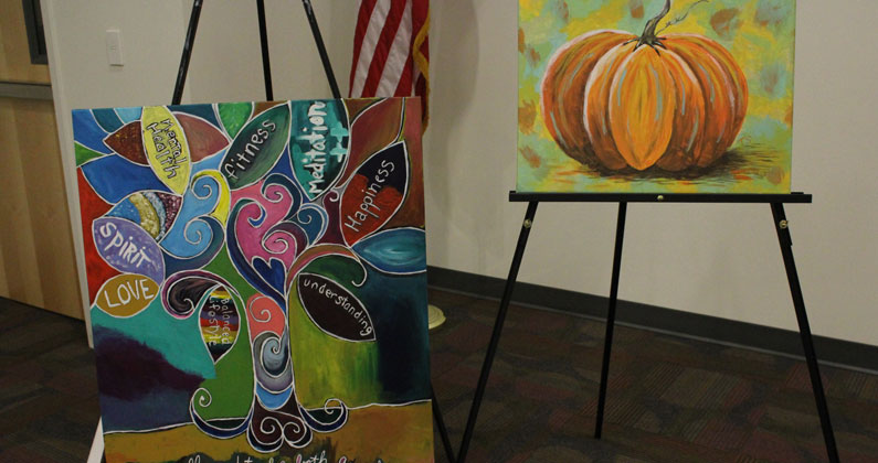 Participant have painted pumpkins, flags and a tree of life.