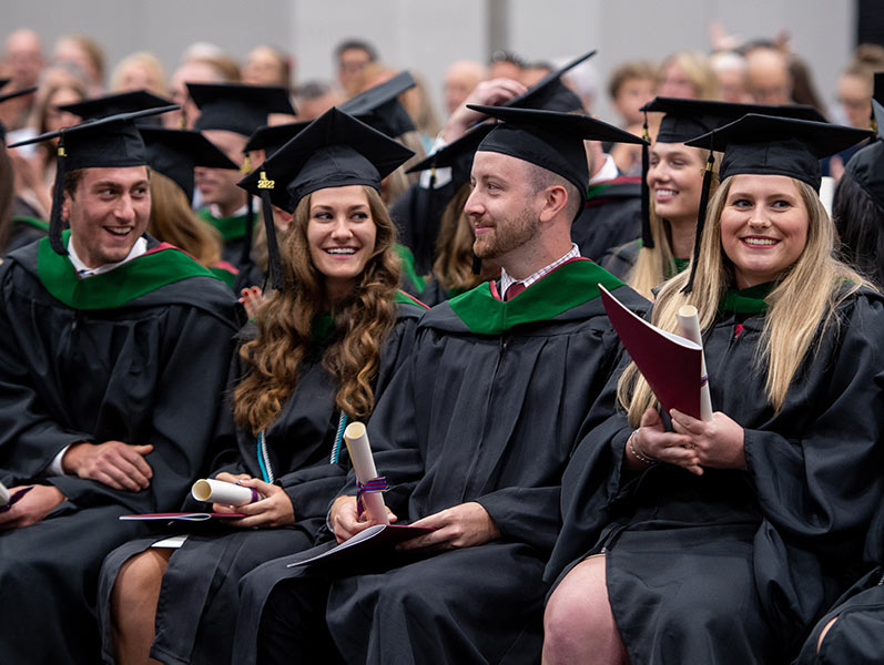 PCOM Georgia graduate students smile during commencement