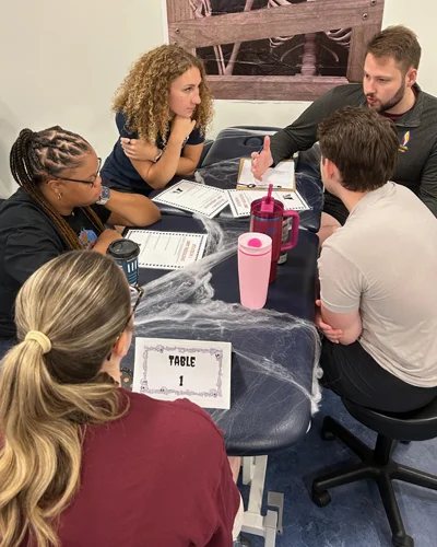 Physical Therapy students gathered around an exam table