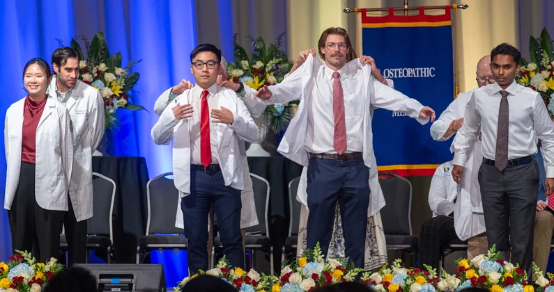 John “Jackson” Norris (DO ‘29) and his classmates receive their white coats