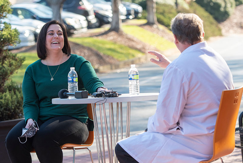 Rachelle Broom and Dr. Donald Penney caught up while being filmed by Fox5 News