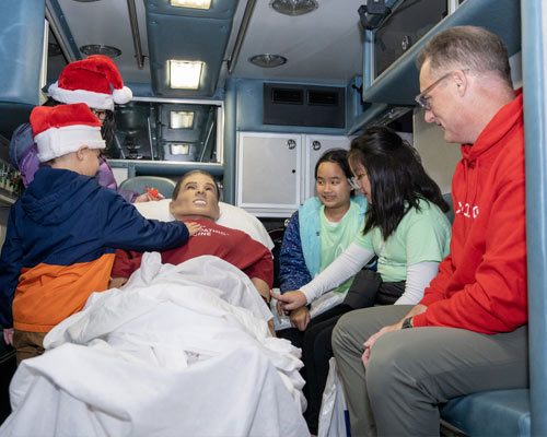 Children explore the simulated ambulance and patient
