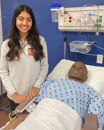 Ritika Vakharia, aspiring medical student, stands in PCOM Georgia's simulation center