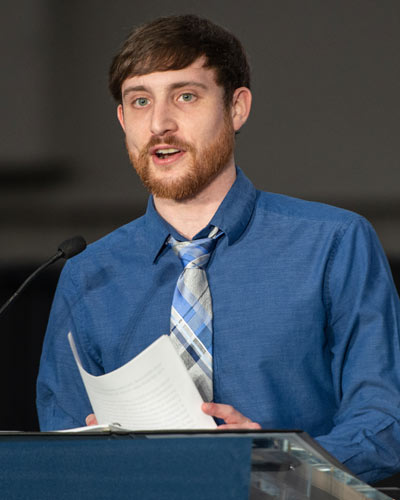 PharmD student, Andrew Wilson, gives speech at podium
