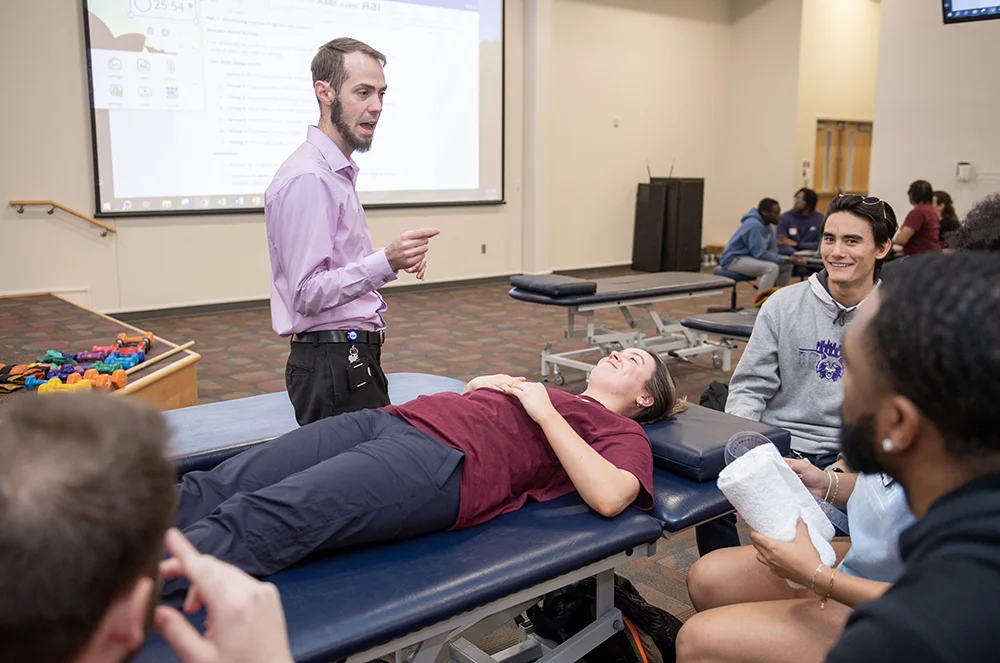A DPT faculty member begins a hands-on learning demo with guests during one of PCOM Georgia's “A Day in the Life of a PT Student” event