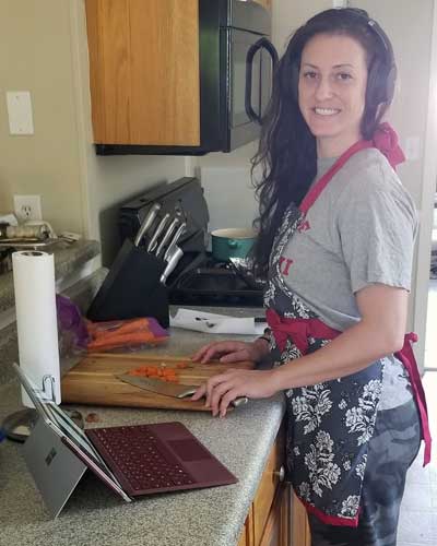 Photo of Brea Echard (DO '23), a culinary medicine class participant, working in a kitchen.