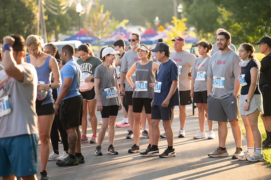 PCOM Georgia students and faculty as well as other community members stand in a park before starting the Blaze 5k event