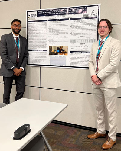 PCOM Georgia Physical Therapy students smile next to their presentation poster