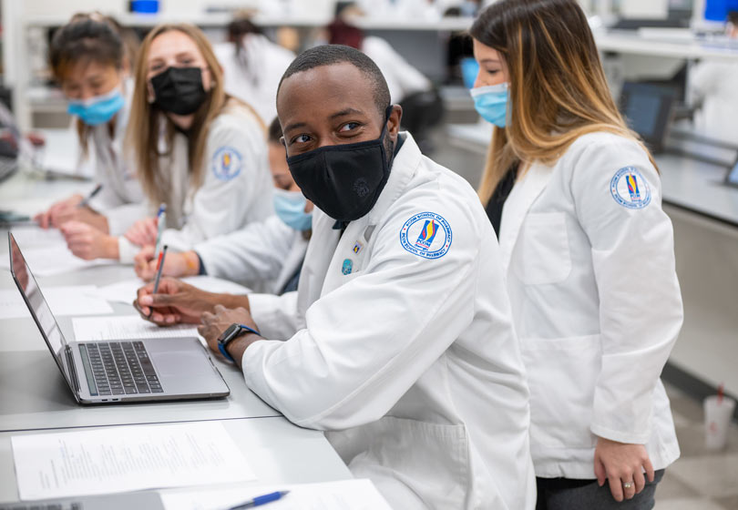 PCOM School of Pharmacy students take notes during class