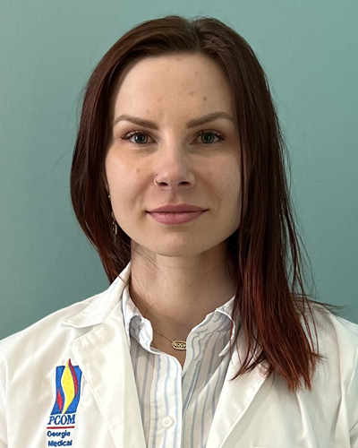 Headshot photo of DO student Inara Patton (DO '26) wearing her student white coat