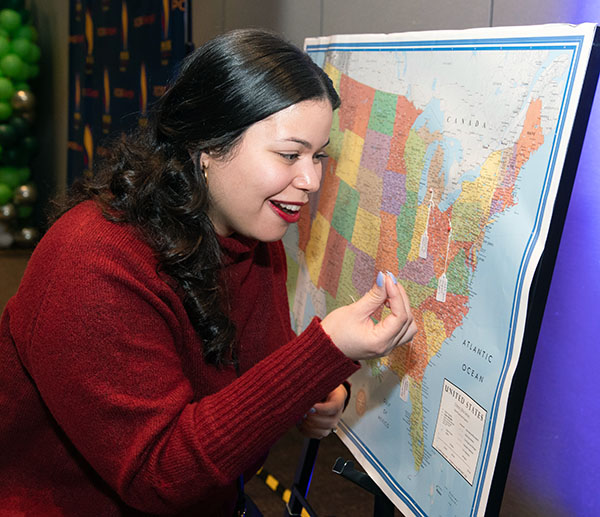 A PCOM Georgia DO student adds her residency match pin to a map during the match day event