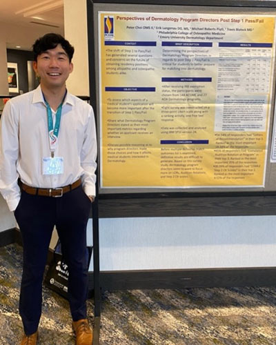 Peter Choi poses with research poster