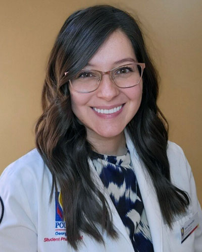 Headshot photo of pharmacy student Sara Hernandez (PharmD '23) wearing her white coat.