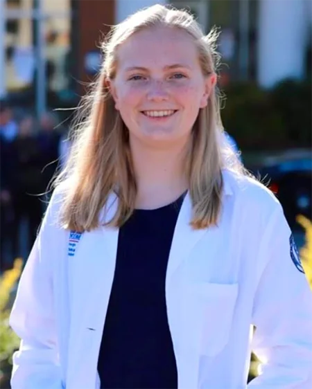 PCOM Georgia med student Jessica Meredith (DO '26) smiles in her student physician white coat