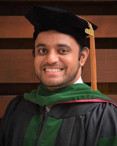 Headshot photograph of Class of 2020 Chair, Ronak Patel, DO '20 wearing his green and black graduation regalia