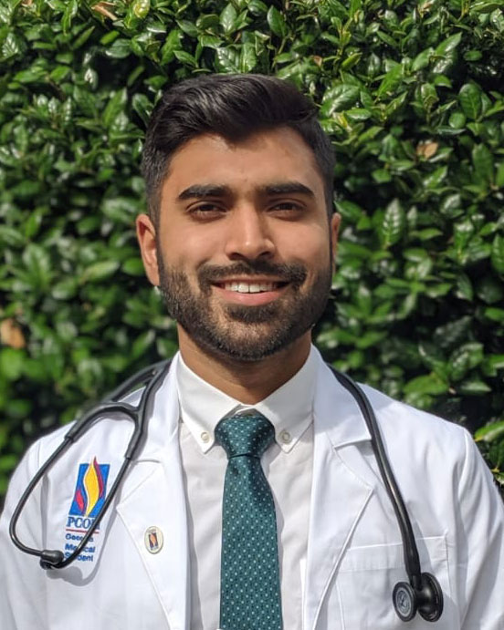 A photo of Prakshal Jain (DO ’23) in his white coat.