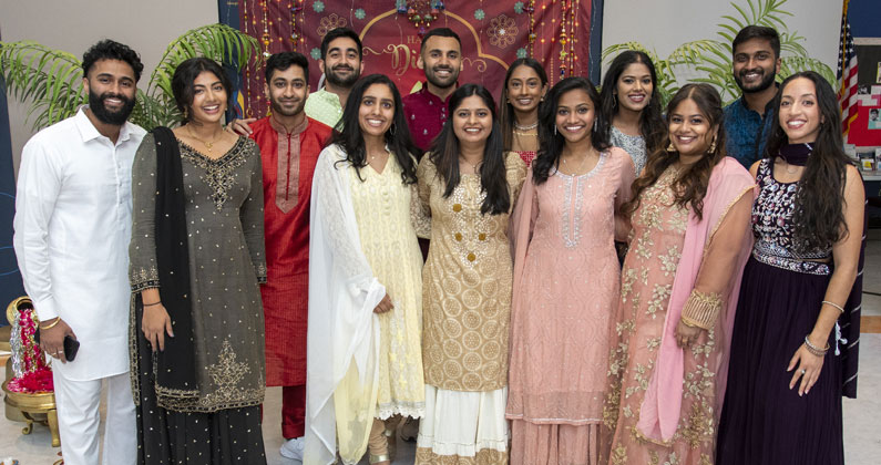 Students pose dressed in Indian clothing during Diwali celebration