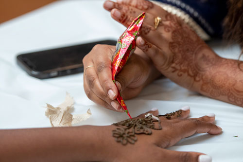An attendee visits the mehndi (henna) station