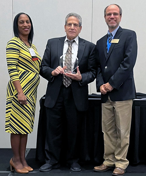 Gary Freed, DO, smiles as he receives the  Leila D. Denmark Lifetime Achievement Award from the Georgia chapter of the American Academy of Pediatrics